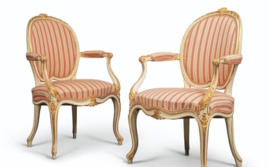 A PAIR OF GEORGE III CREAM-PAINTED AND PARCEL-GILT OPEN ARMCHAIRS