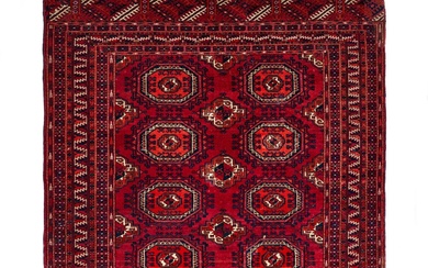 A RED HAND KNOTTED WOOL RUG FROM BOKHARA, UZBEKISTAN...