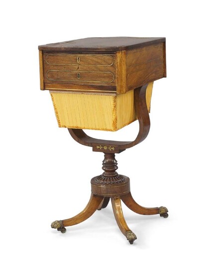 A Regency brass inlaid rosewood sewing table, early 19th century, with lyre support raised on turned column, four splayed legs to brass lion paw caps and castors, 73cm high, 35cm wide, 46cm deep