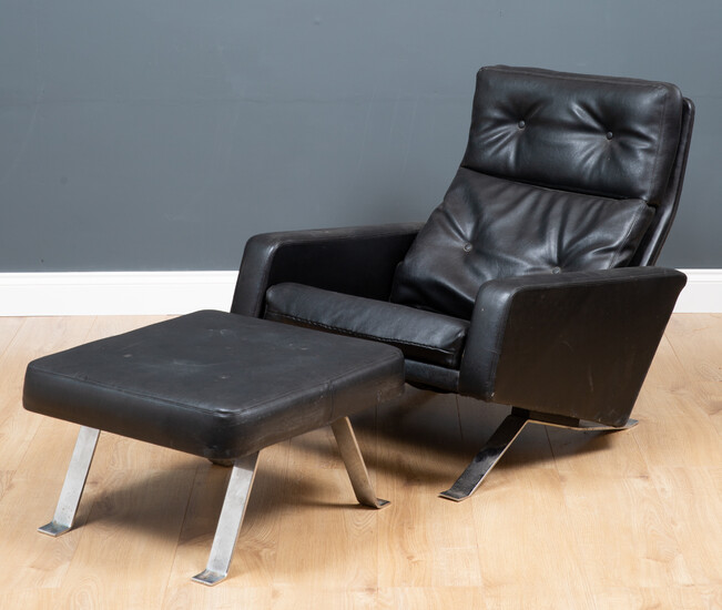 A Robin Day Leo black leather low armchair and footstool...