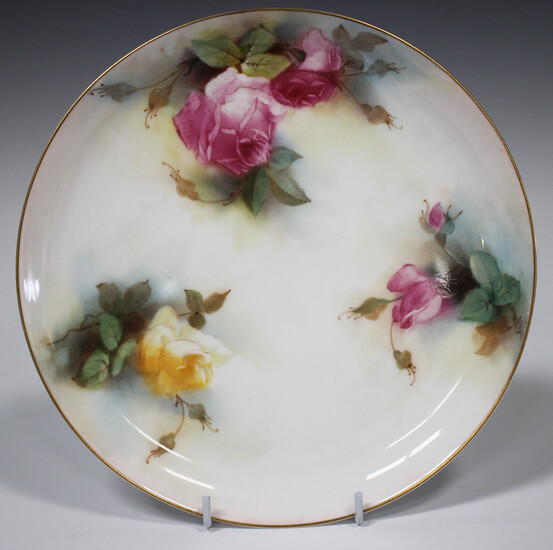 A Royal Worcester plate, circa 1913, painted by K.H. Blake, signed, with pink and yellow roses in bu