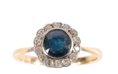 A SAPPHIRE AND DIAMOND CLUSTER RING the round-cut sapphire, ...