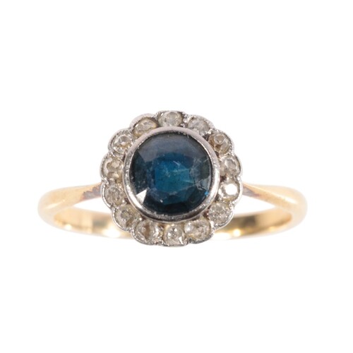 A SAPPHIRE AND DIAMOND CLUSTER RING the round-cut sapphire, ...