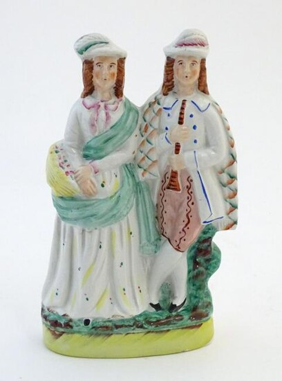 A Staffordshire pottery figural group depicting two