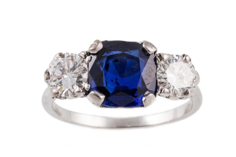 A THREE STONE SAPPHIRE AND DIAMOND RING, mounted in platinum