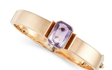 A VINTAGE AMETHYST BANGLE in 14ct yellow gold, the hinged bangle set with an octagonal step cut