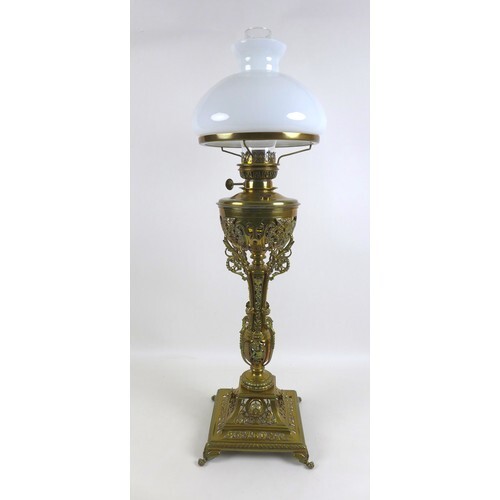 A Victorian brass paraffin lamp, with brass reservoir on a c...