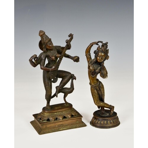A bronze Hindu Saraswati figure, playing a lute with bird be...