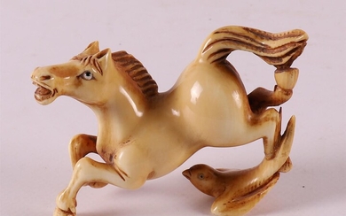 (-), A carved ivory jumping horse with bird,...