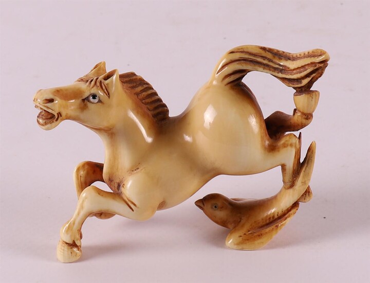 (-), A carved ivory jumping horse with bird,...