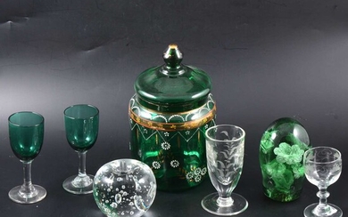 A green glass paperweight and one other, two green stemmed glasses