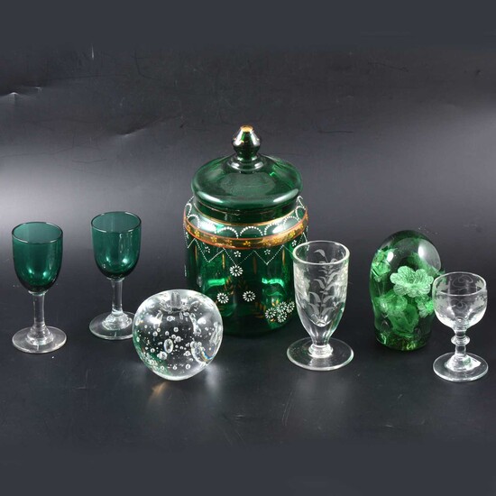 A green glass paperweight and one other, two green stemmed glasses