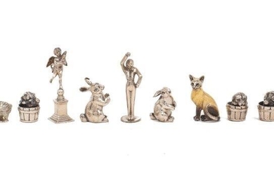 A group of novelty animals comprising: three puppies in buckets, stamped 925, two chicks, stamped 833, two bunnies, stamped 925, an enamelled Siamese cat ornament with silver plated head and tail, two figural statues, one stamped 900, the other...