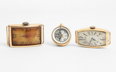 A group of two gold wrist watches and a compass