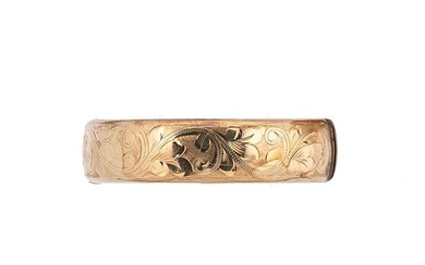 A late 20th century 9ct gold half engraved bangle