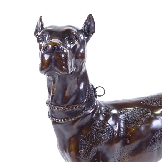 A patinated bronze standing dog, signed on the tail, height ...