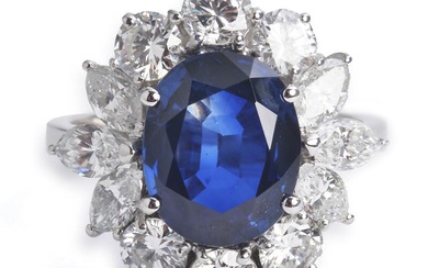 A sapphire and diamond ring set with an oval-cut sapphire weighing app. 3.60 ct. encircled by six marquise-cut and six brilliant-cut diamonds weighing a total of app. 1.20 ct., mounted in 18k white gold. Colour: Top Wesselton-Wesselton (G-H). Clarity:...