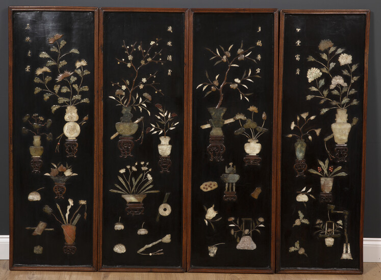 A set of four decorative Chinese black lacquered panels