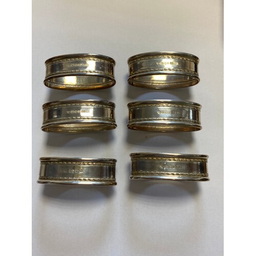 A set of six silver napkin rings, London 1991