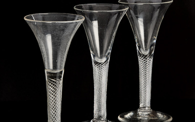 A set of three 17th/19th century wine glasses. Foot with enclosed spiral decor, trumpet-shaped bowl. A glass of ice cream.