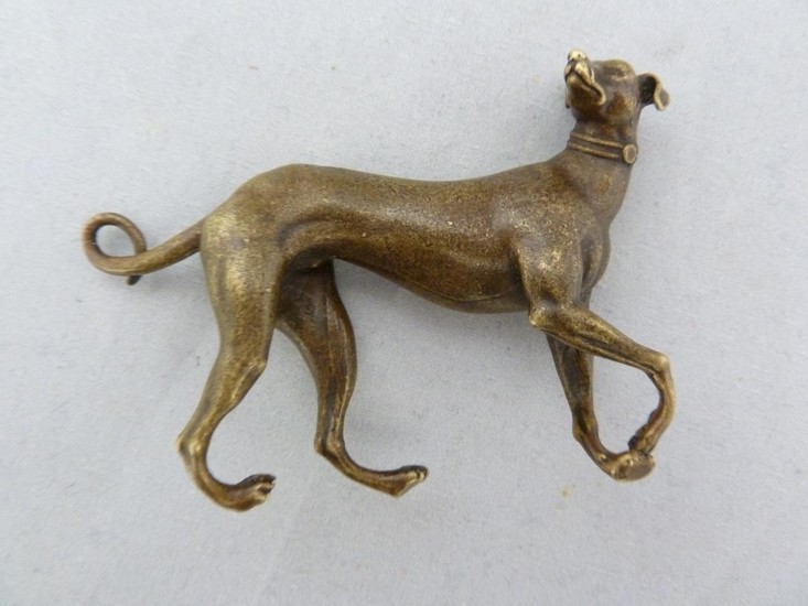 A small bronze figure of a grey hound, naturalistically mode...