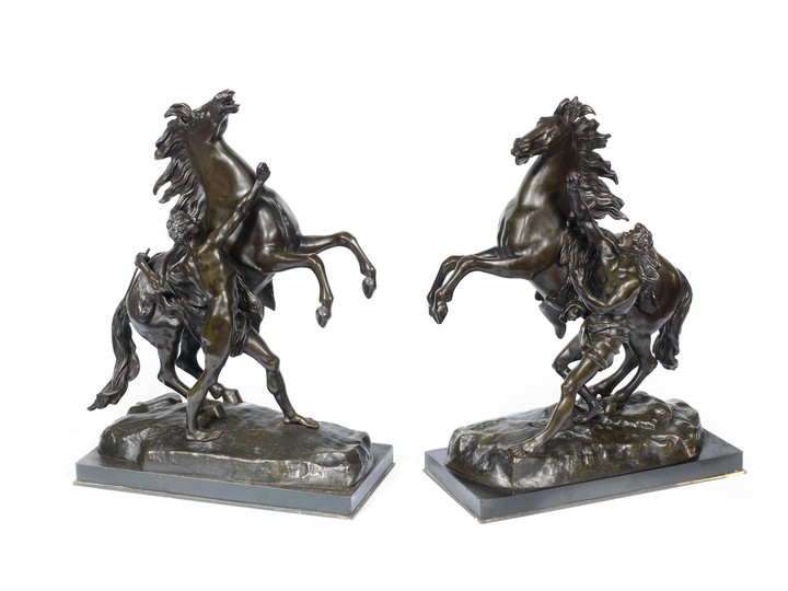 After Guillaume Coustou, French (1677-1746): A pair of late 19th century/early 20th century patinated bronze models of the Marley horses