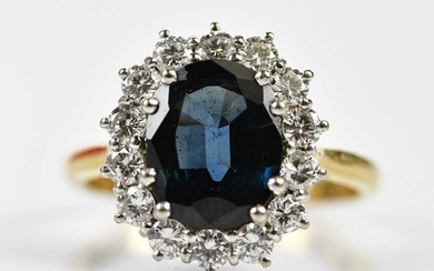 An 18ct yellow gold sapphire and diamond oval cluster ring,...