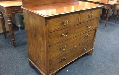 An Edwardian mahogany chest of drawers, with low back to...