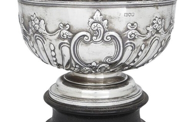 An Edwardian silver rose bowl on stand, London, 1901, Charles Stuart Harris, the fluted body repousse decorated with floral and scroll motifs, 23.5cm high (inc. stand), 16cm high (without stand), 23.6cm dia., approx. weight 23.5oz