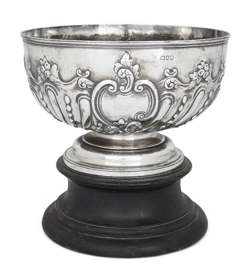 An Edwardian silver rose bowl on stand, London, 1901, Charles Stuart Harris, the fluted body repousse decorated with floral and scroll motifs, 23.5cm high (inc. stand), 16cm high (without stand), 23.6cm dia., approx. weight 23.5oz