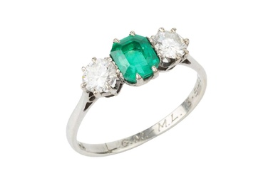 An emerald and diamond three stone ring, the emerald cut...