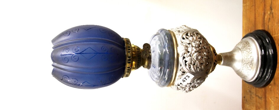 An unusual 19th century silvered cast metal oil lamp with etched blue glass shade, overall H. 64cm.