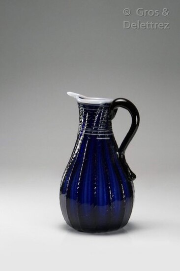 Blue ribbed glass jug decorated with white threads.