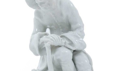 Bow blanc de chine figure, circa 1755, in the form of a seated elderly man warming his hands on a brazier, emblematic of Winter, 12.5cm high