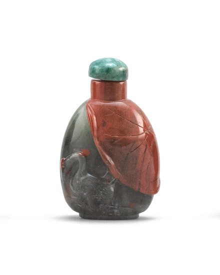 CHINESE JASPER SNUFF BOTTLE In spade shape, with red and black crane and lotus leaf design. Height 1.8". Jadeite stopper.
