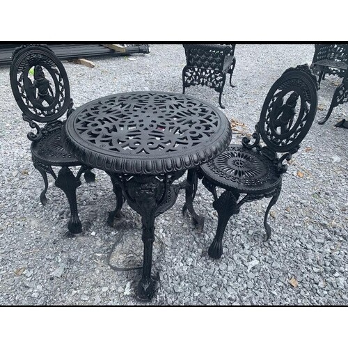 Cast iron three piece garden set - table and two chairs.
