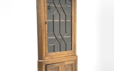 Early 19th century oak floor standing corner cupboard, projecting...