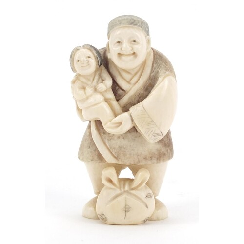 Japanese carved ivory netsuke of a man holding a child, char...