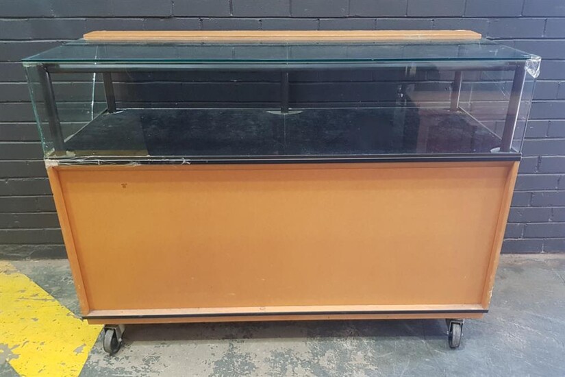 Large Timber and Glass Display Case on Castors - large crack to glass and scratching to top (H:110 x W:150 x D:62cm)