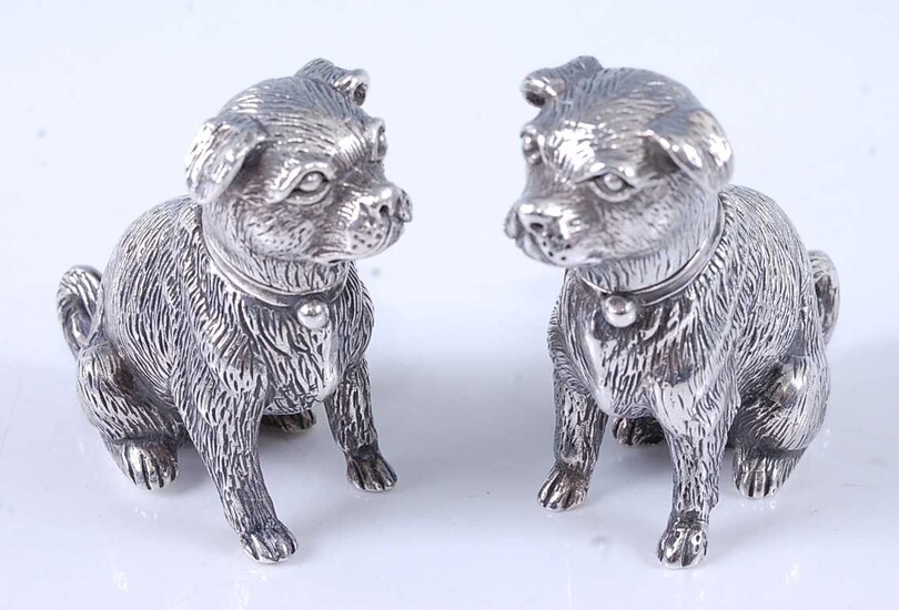A pair of cast silver novelty pepperettes