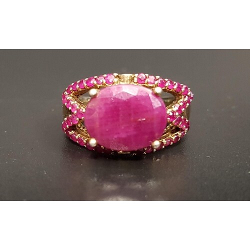 RUBY DRESS RING the large central oval cut ruby approximatel...
