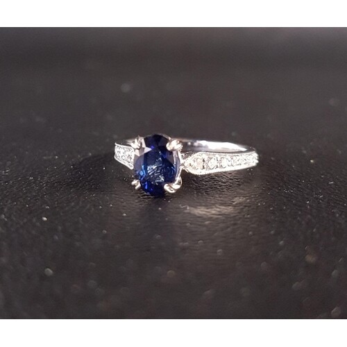 SAPPHIRE AND DIAMOND RING the central oval cut sapphire tota...
