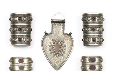 Turkmenistan, two pair silver armlets, one with ormolu and cornelians, the other with coloured stones; herewith a silver, gilt-silver heart-shaped back pendant.