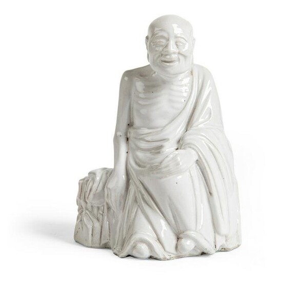 WHITE-GLAZED FIGURE OF AN ARHAT QING DYNASTY, 18TH-19TH
