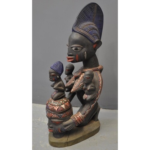 West African female polychrome decorated carved wooden offer...
