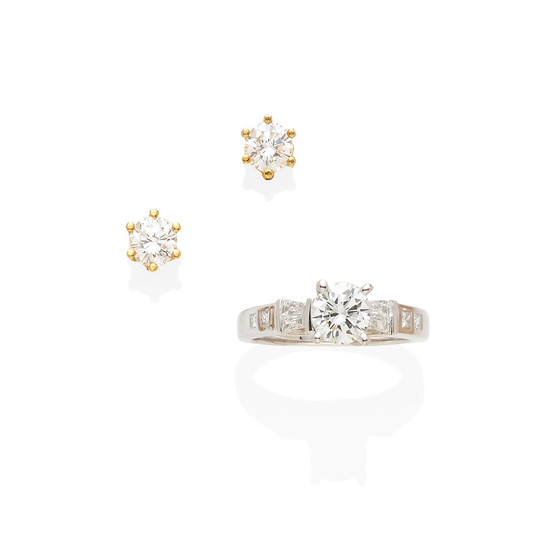 a diamond ring together with a pair of diamond stud earrings