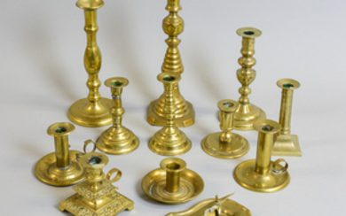 Eleven Brass Candlesticks, a Pair of Wick Cutters, and a Tray