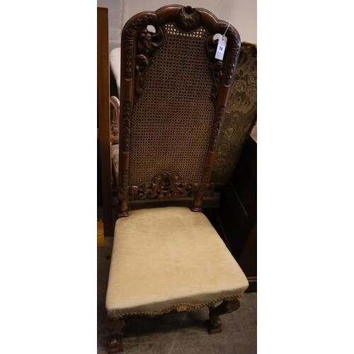 A 19th century Flemish style carved walnut armchair, upholst...