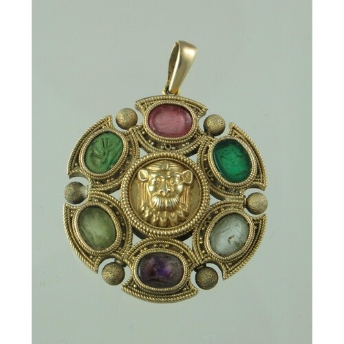 A 19th century circular yellow metal pendant decorated with ...