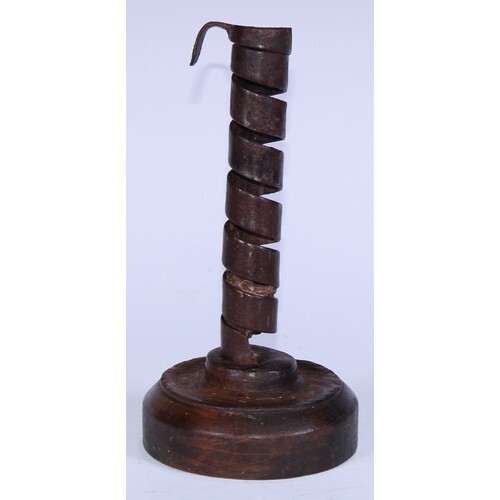 A 19th century wrought iron spiral candlestick, softwood bas...